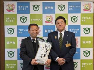 林市長と搬入した備蓄品を持つ石川市長の画像