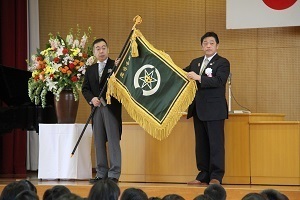 八海中学校開校式で校旗を校長へ渡す林市長