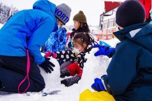 児童たちが協力して雪像を作成している様子